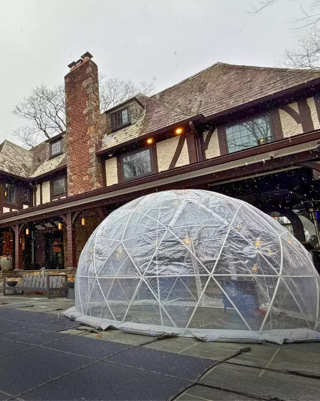 Clear outdoor igloo tents installed on a university campus for a winter-time student event.